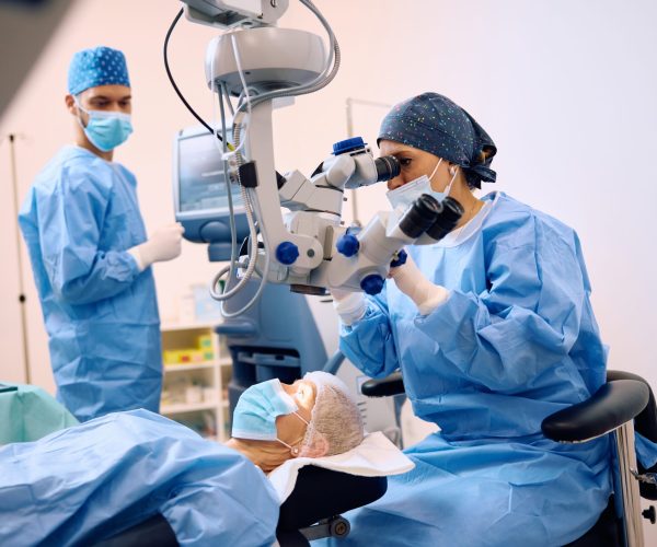 Medical,Expert,Using,Microscope,While,Performing,Eye,Surgery,At,Ophthalmology